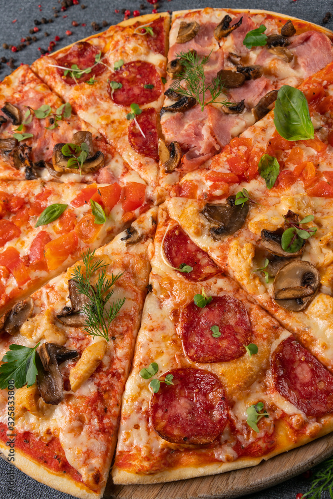 Different slices of pizza on wooden board on the table Different slices of pizza on wooden board on the table