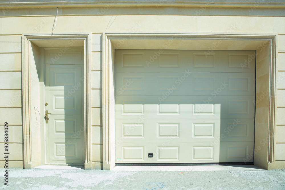 Fototapeta premium Shutter door or roller door and concrete floor outside .White Automatic shutters in a house . gates in the garage . Automatic Electric Roll-up Gate Or Push-up Door In Building Ground Floor .