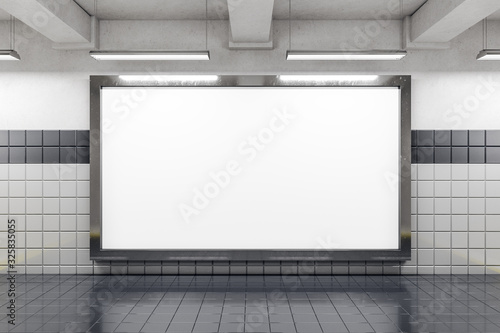 Front view of empty subway poster on white wall.