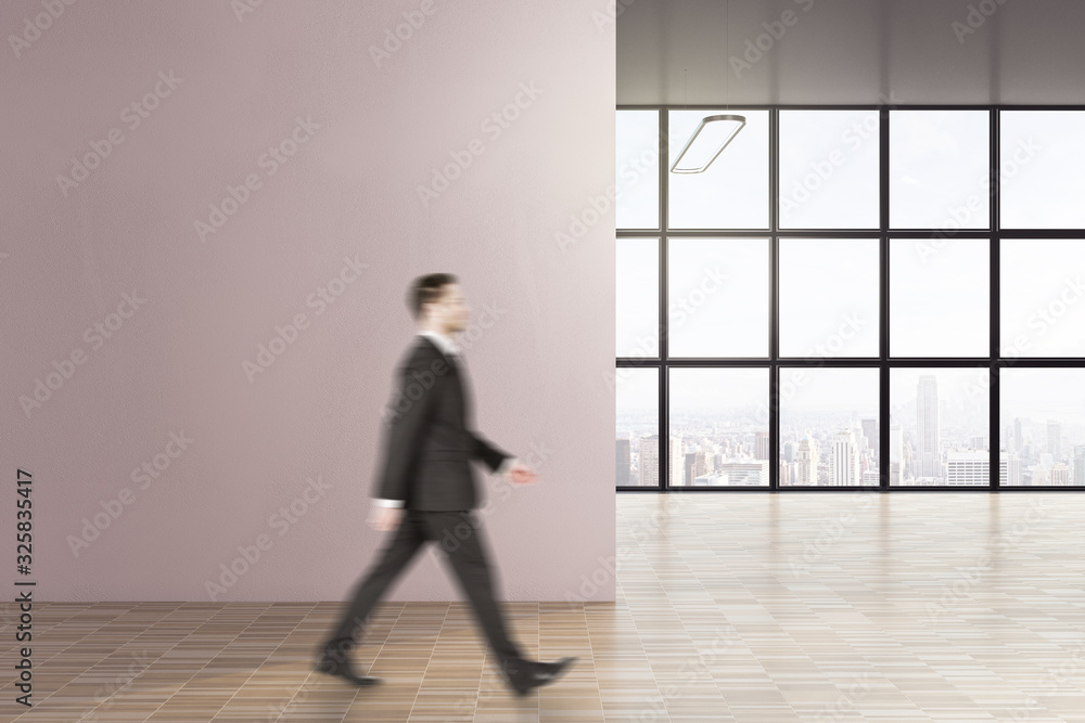Businessman walking in modern interior with copy space on wall. Businessman walking in modern interior with copy space on wall.