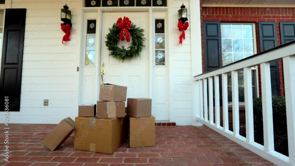 Boxes by front door during holiday shopping season, dolly right to left Boxes by front door during holiday shopping season, dolly right to left