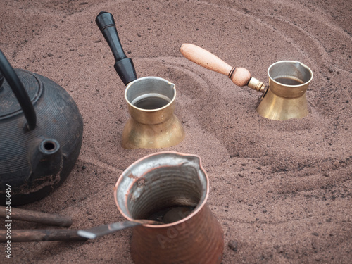 Turkish coffee made with hot sand preparation on the street during food festival. Also Egyption coffee recipe. Authentic traditional stand photo