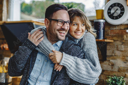 Canvas Print Portrait of embraced couple in the kitchen.