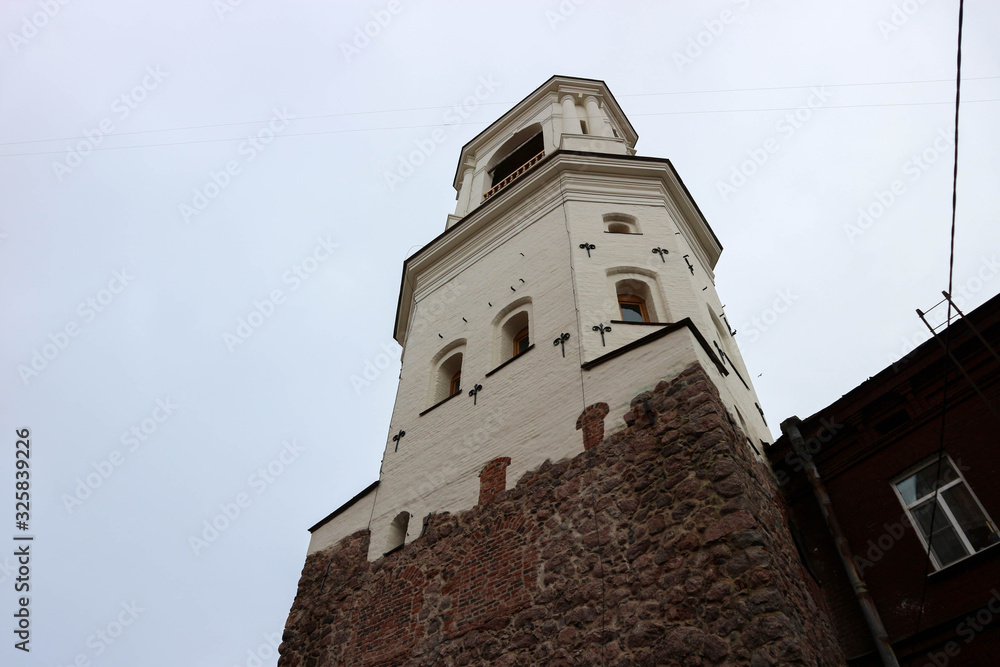 old white clock tower in Vyborg, Russia