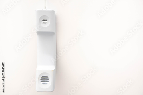 white telephone receiver on white background