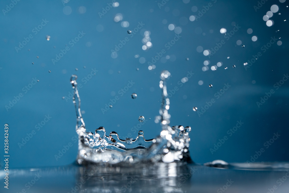 Water Drop falling making droplet splash and waves clean and fresh symbol.