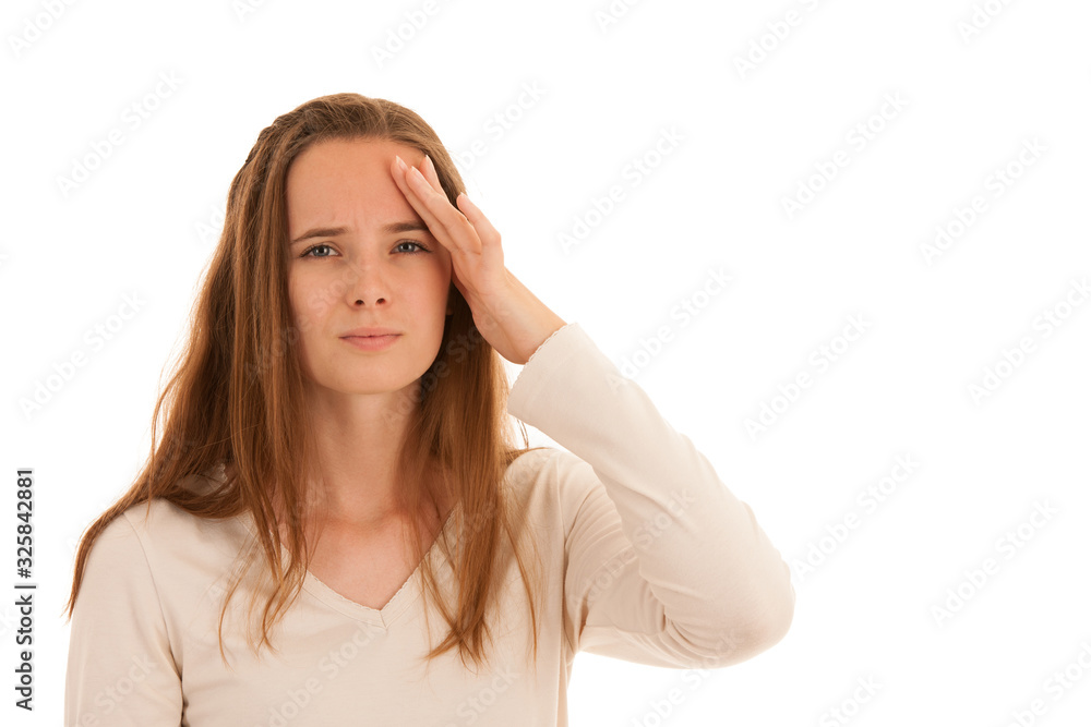 Beautiful young brunette woman holds her head as she has headache - illness Beautiful young brunette woman holds her head as she has headache - illness