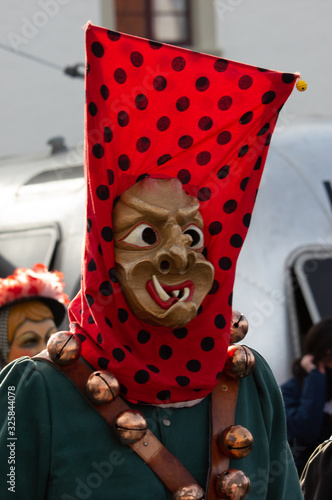 Closeup Portrait of a masked person on a carnival parade photo