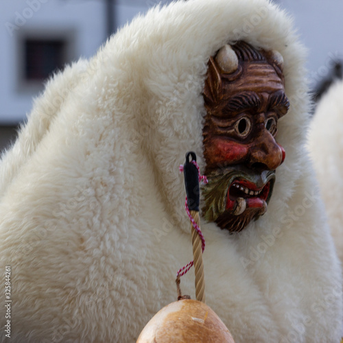 Closeup Portrait of a masked person on a carnival parade photo