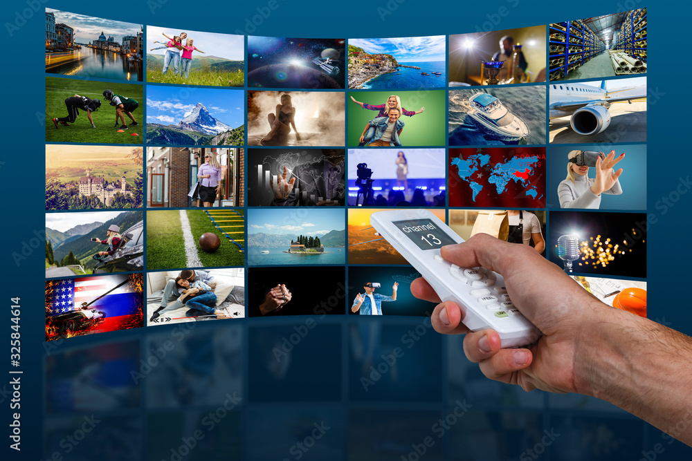 Hand holding television remote control pressing buttons, control switches different channels, many screens Hand holding television remote control pressing buttons, control switches different channels, many screens