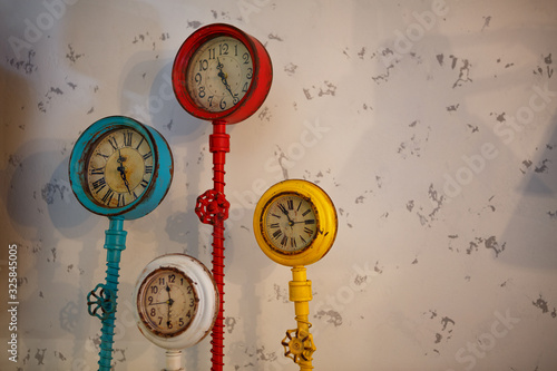 Creative multi-colored vintage clock in loft style