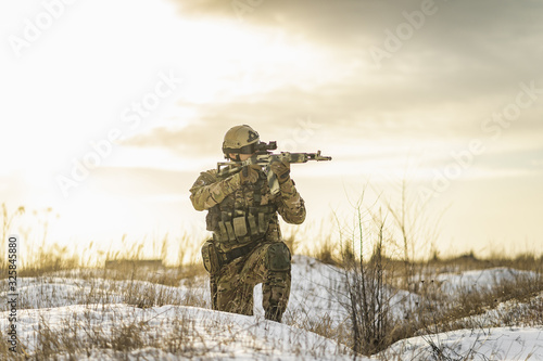 Cuadro en lienzo Modern Ukraine war soldier army Man in the winter multicam camouflage is patrolling or patrol field territory against Russians
