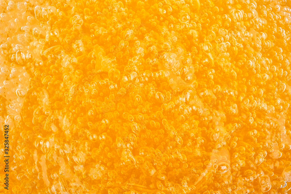 Transparent can of orange massage gel Transparent can of orange massage gel