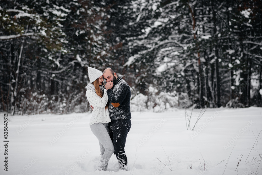 Couple playing with snow in the forest