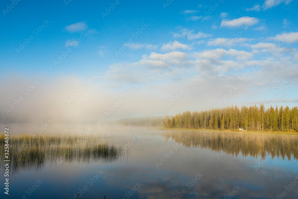 Morning sunlight burns off cloud over Lac Le Jeune Lake, Canada. Morning sunlight burns off cloud over Lac Le Jeune Lake, Canada.