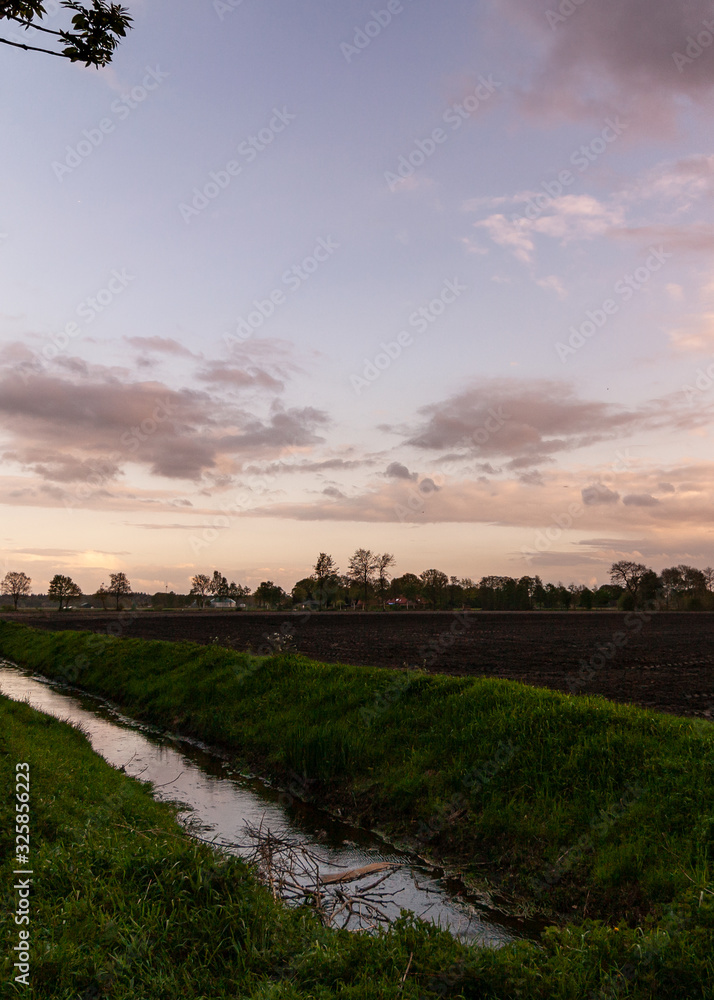 sunset over a field with a canal, Noth of Germany 