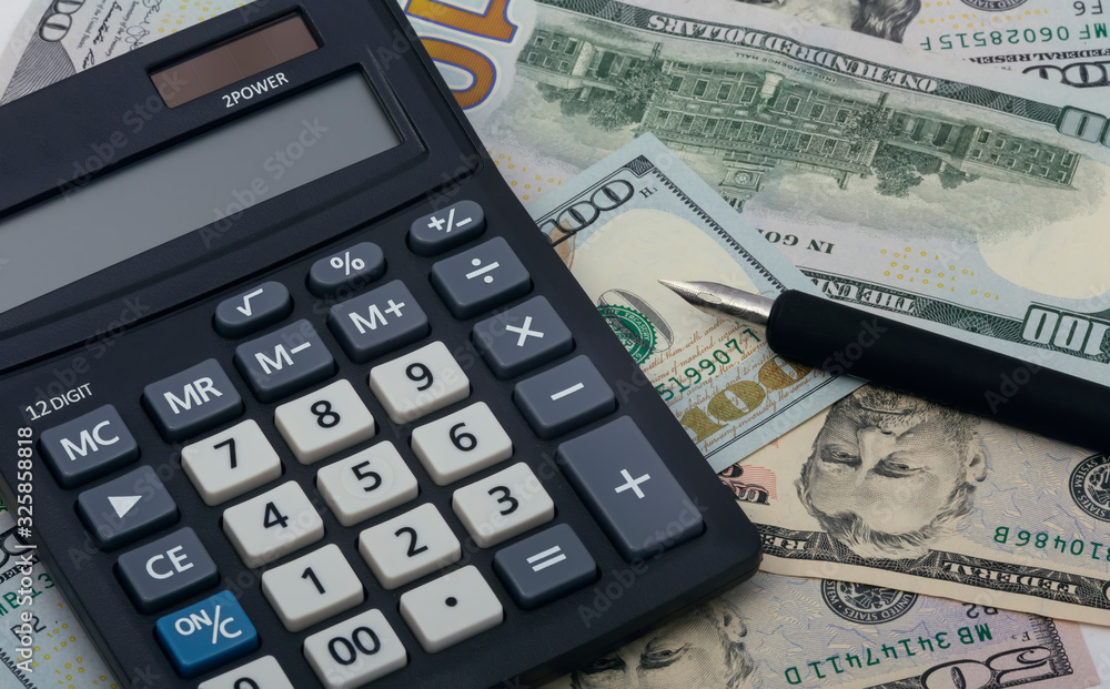 Calculator, dollars and fountain pen. Close-up. Calculator, dollars and fountain pen. Close-up.
