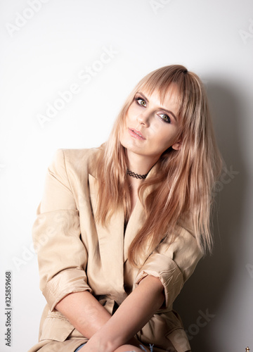 portrait of a blonde in a jacket on white background