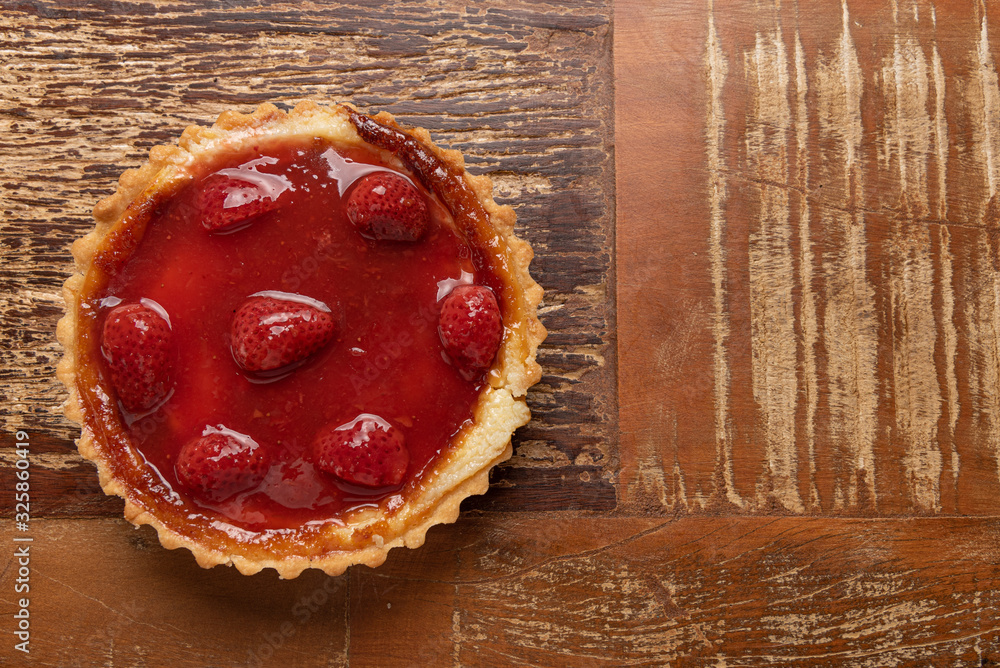 Homemade strawberry pie with and a golden crust, on wooden background Homemade strawberry pie with and a golden crust, on wooden background