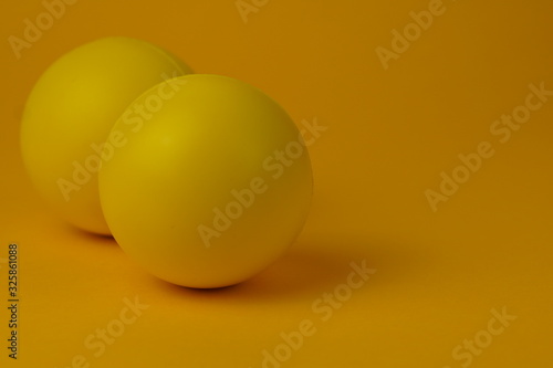 Yellow glossy game ball close-up on a yellow background.Yellow ball.
