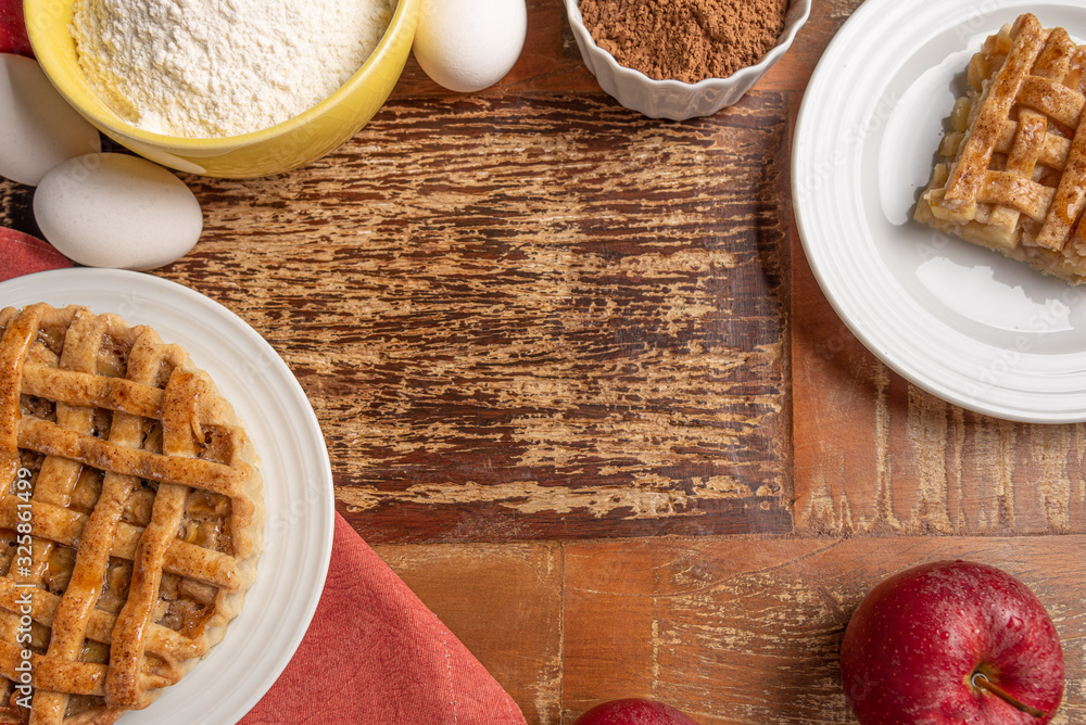 Homemade apple pie with cinnamon and a golden crust, on a wooden background Homemade apple pie with cinnamon and a golden crust, on a wooden background