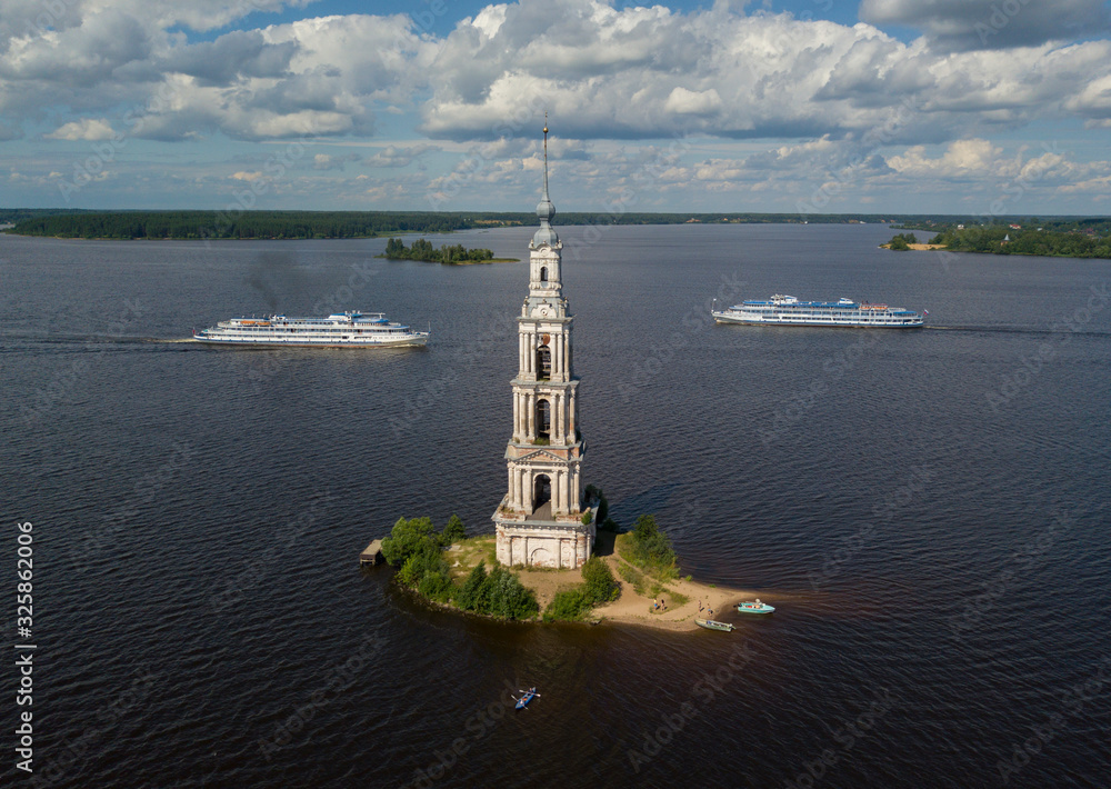 A ships float past the famous Kalyazin Bell Tower part of