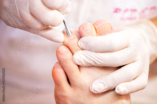 Cuticle treatment for pretty and clean toenails  men   s pedicure toenail concept