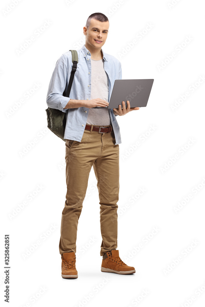 Male student standing and using a laptop computer Male student standing and using a laptop computer