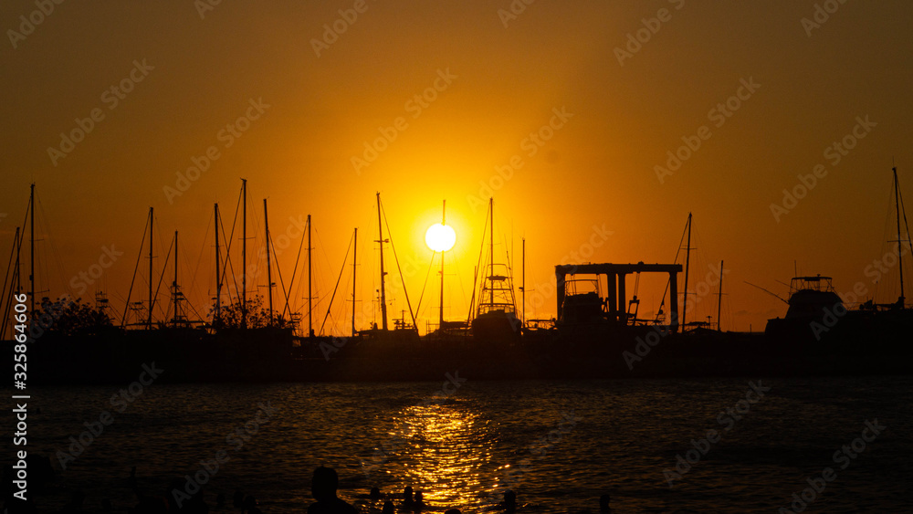 Sunset with boats at beach