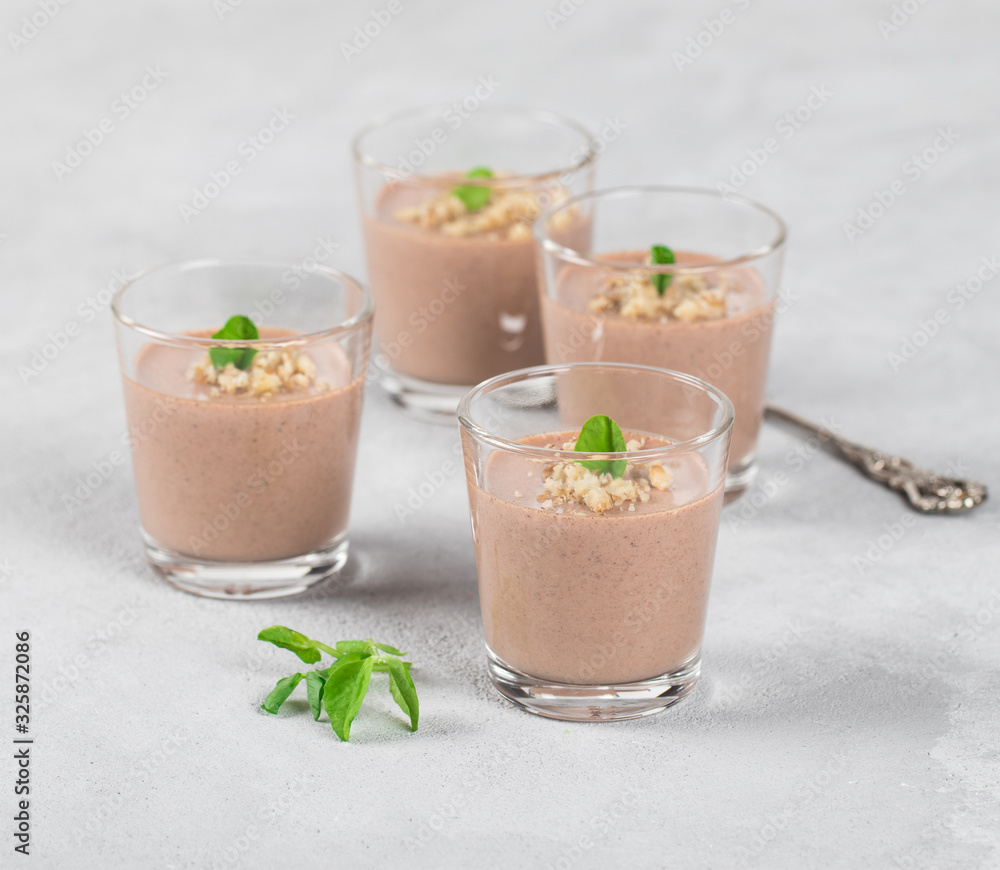 Chocolate nut jelly in a glass on a light background Chocolate nut jelly in a glass on a light background