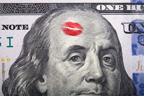 Imprint of the kiss on portrait of Benjamin Franklin on a hundred dollar bill. photo