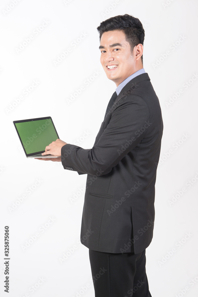 Businessman wears a black suit. Smiling face Use a laptop to view various information. Businessman wears a black suit. Smiling face Use a laptop to view various information.