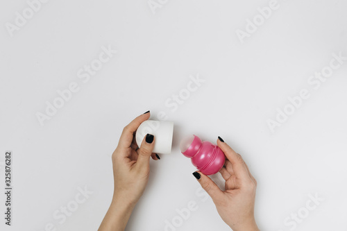 Roll-on deodorant with a pink lid open 