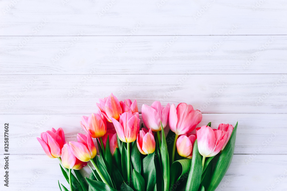 Fresh pink tulip flowers on wooden table. Top view with copy space Fresh pink tulip flowers on wooden table. Top view with copy space