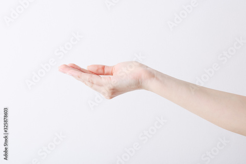 Empty female hand making gesture like holding something on white background.