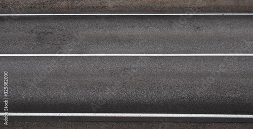 Asphalt highway texture with three white stripes