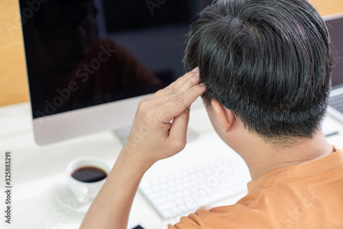 Tired Asian men work at home