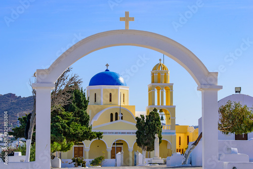 Yellow church with blue dome in Oia, Santorini, Greece