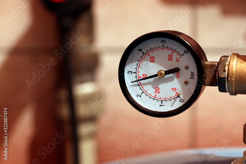A gauge, manometer, gage on a bright background.