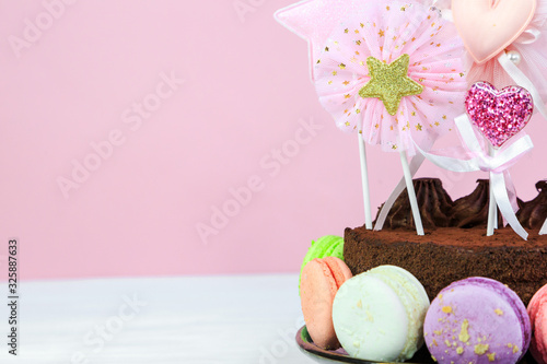 Fresh cholocate delicious  cake with maracoons around it on the table. Close up. Birthday cake for party photo