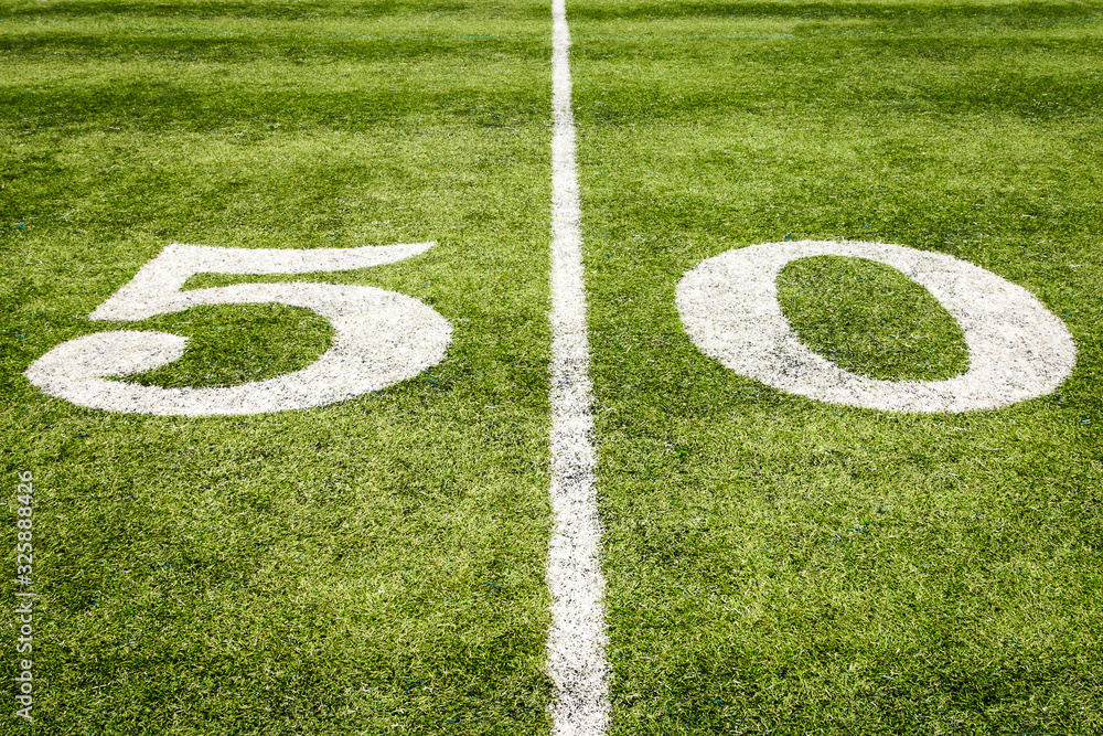 Football Field 50 Yard Line on the Grass with Artificial Turf Football Field 50 Yard Line on the Grass with Artificial Turf