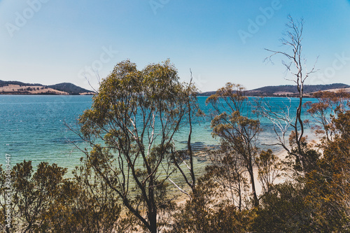 wild Tasmanian landscape and pristine turquoise water of the Derwent River as seen from Legacy Beach walking track