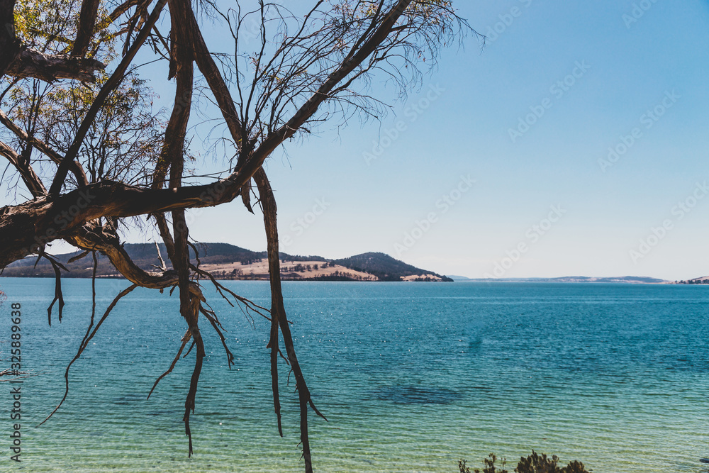 wild Tasmanian landscape and pristine turquoise water of the Derwent River as seen from Legacy Beach near Coningham beach south of Hobart wild Tasmanian landscape and pristine turquoise water of the Derwent River as seen from Legacy Beach near Coningham beach south of Hobart
