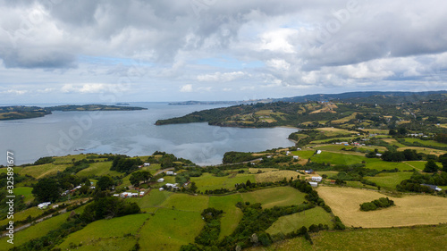 Aerial view of a bay with small islands and farms at Chiloe, Chile photo