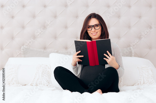 Pregnant Woman Reading a Book in Bed