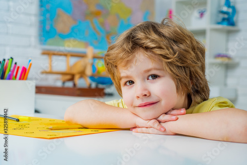 Portrait of Pupil in classroom. First school day. Pupil learning letters and numbers.