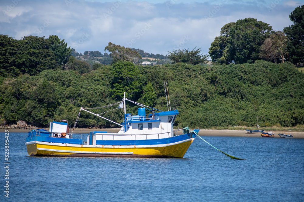 fishing boat on a bay at Chiloé Chile fishing boat on a bay at Chiloé Chile