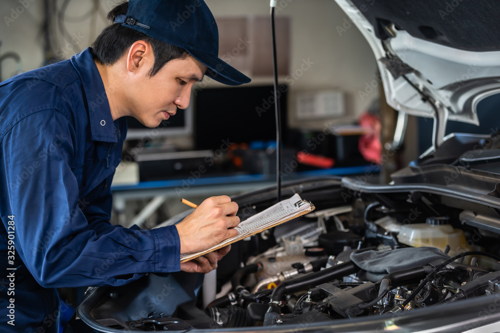 male mechanic checking and repair service car with clipboard male mechanic checking and repair service car with clipboard