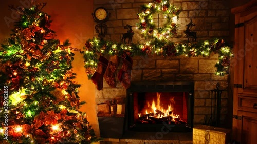Glorious 4k shot of firewood flame burning fireplace loop in cosy festive Christmas tree New Year decoration Noel room