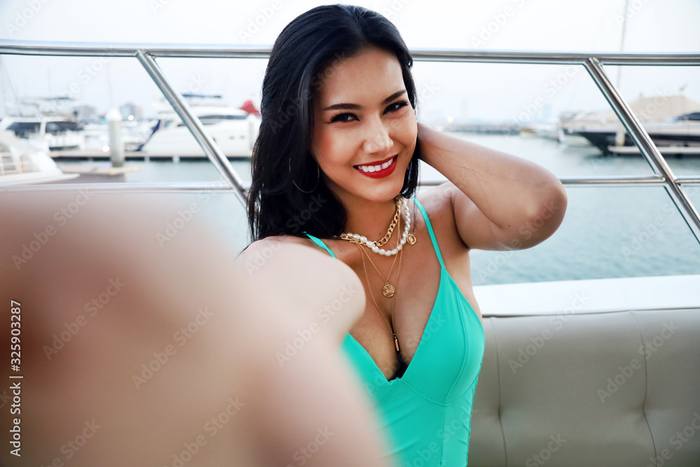 Beautiful Asia young woman smile portrait selfie photo traveling on speed boat in summer for relaxation at Thailand. Beautiful Asia young woman smile portrait selfie photo traveling on speed boat in summer for relaxation at Thailand.